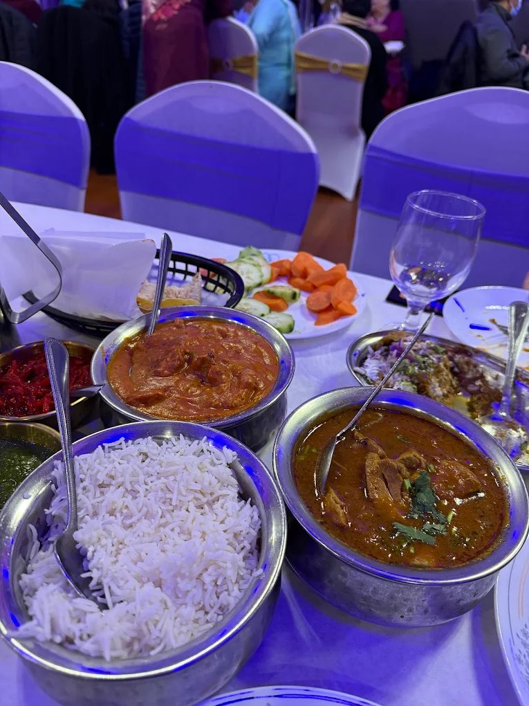 Curry, rice, and sides spread at Daana Paani